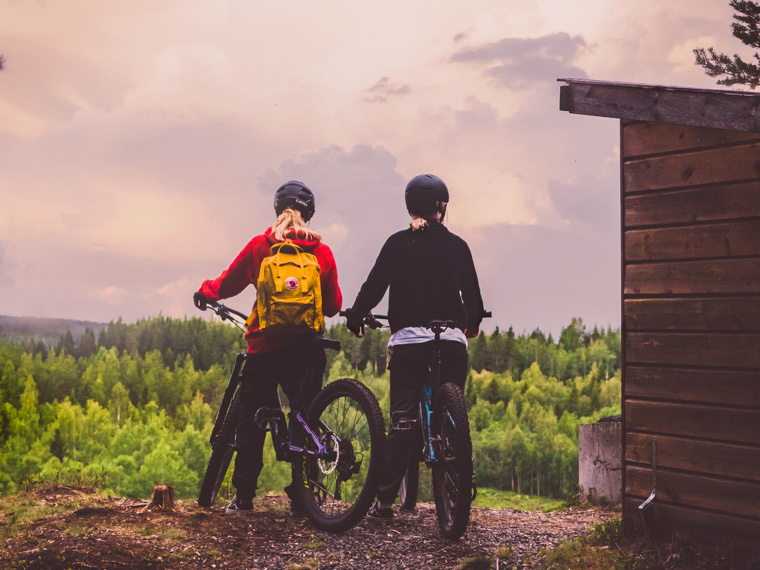 Hanna and Jeanette are standing with the bikes up on a hill enjoying the view.