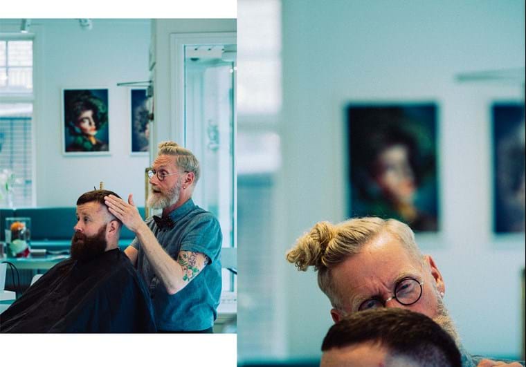 Fredrik gives a customer a haircut at the salon.