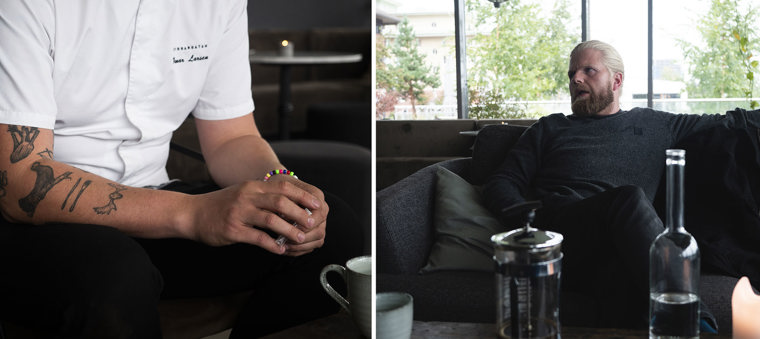 Jon Oskar is sitting on the sofa, on the table in front is a coffee cup, coffee pot, and glass water bottle.