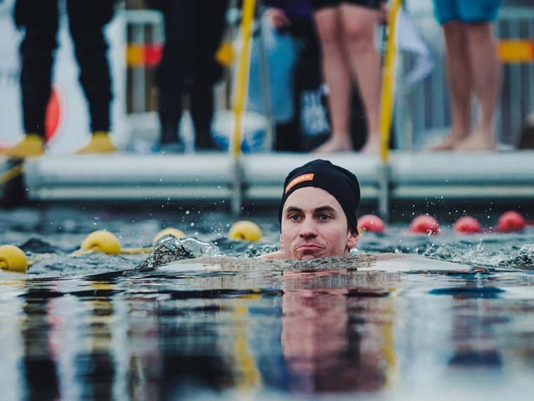 A contestant in the Winter Swimming Championship swims in the icey water